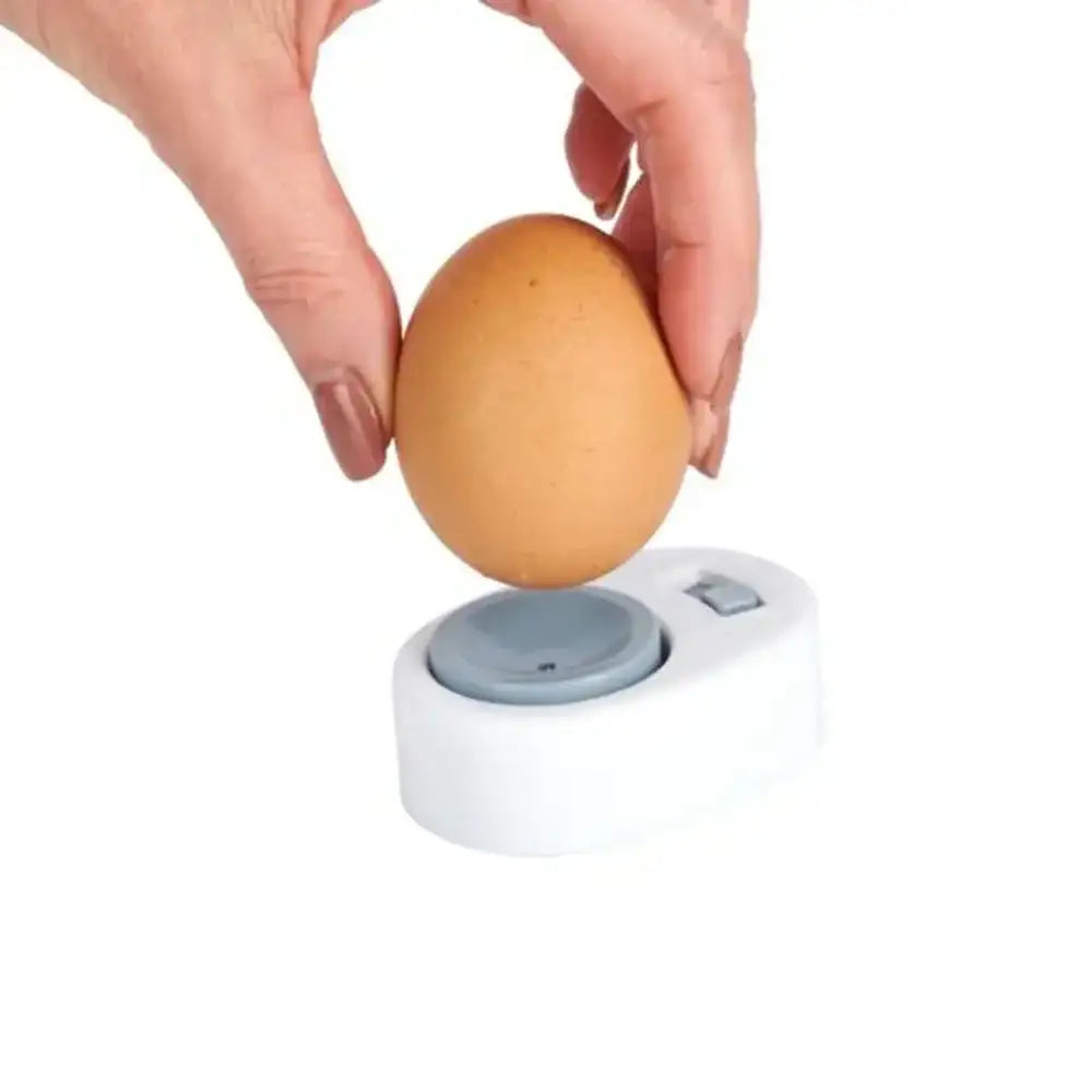 Person using an egg holder to crack an egg on a white background