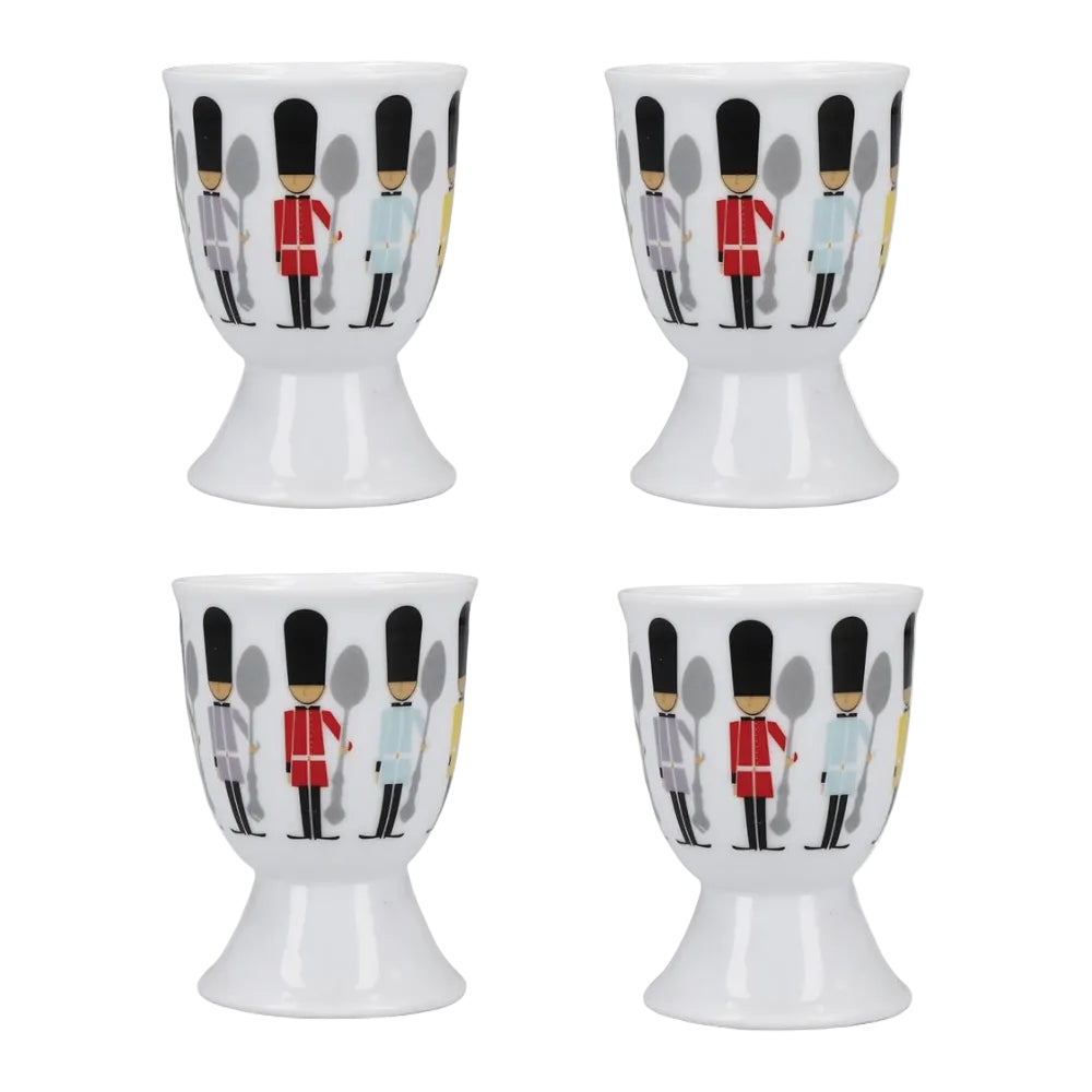 Four white egg cups with a pattern of soldiers in red and blue uniforms on a white background