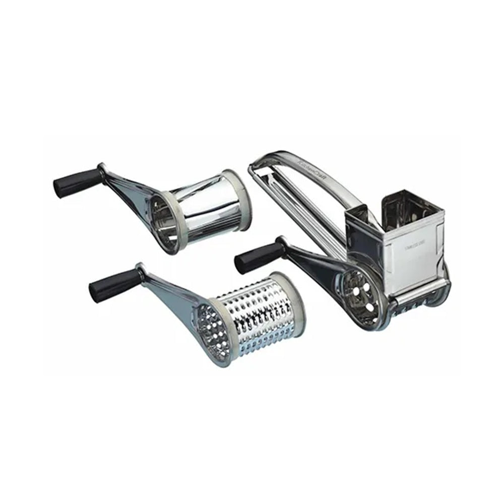 Set of metal kitchen tools including a slicer, shredder, and peeler on a white background