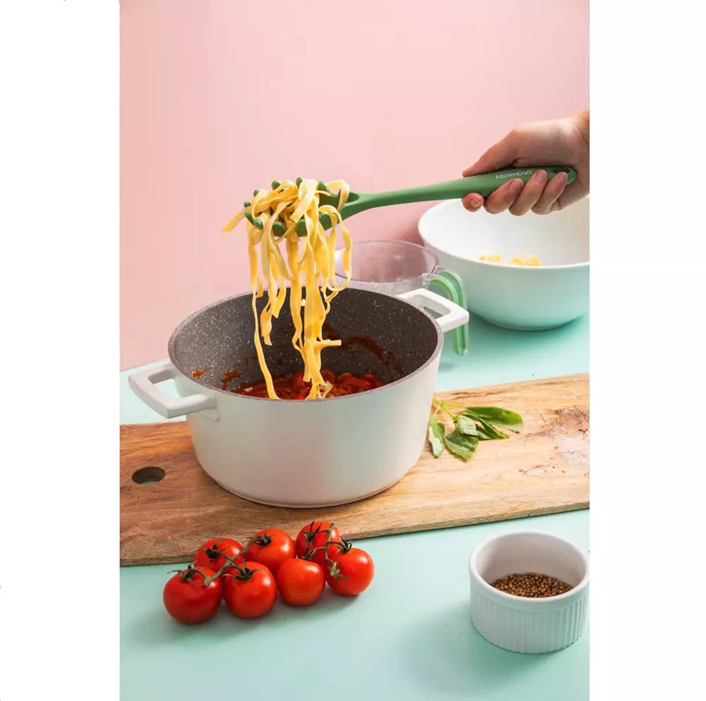 Person serving pasta from a pot with a green spoon on a pink and green background