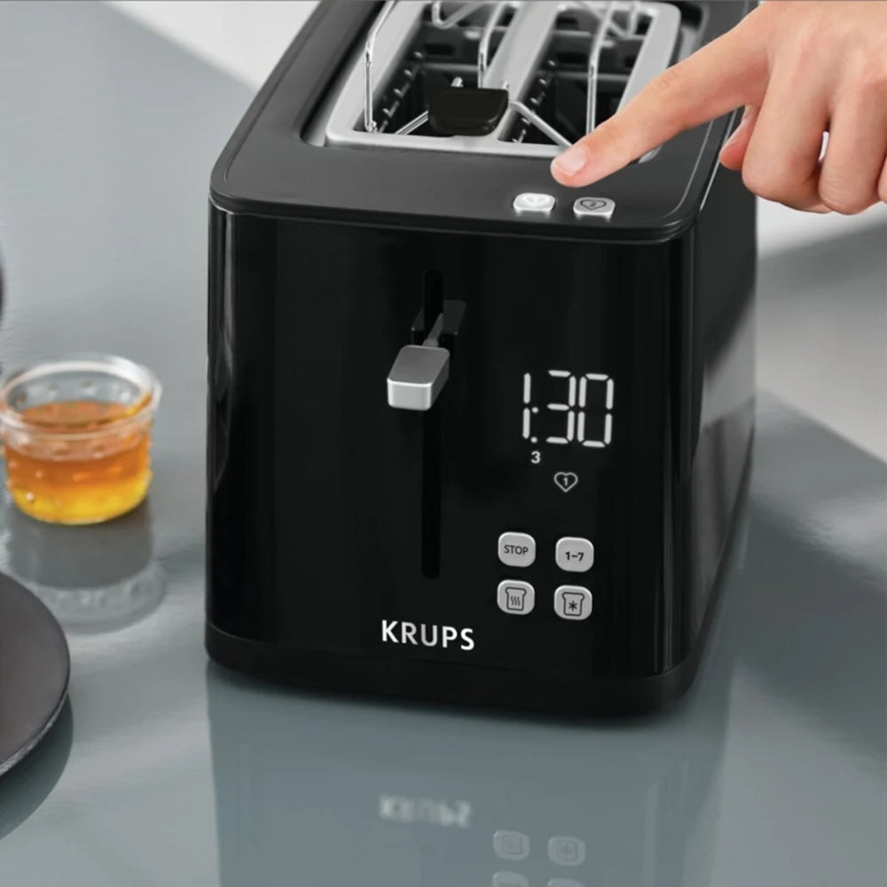 Black Krups toaster with digital display on a kitchen counter