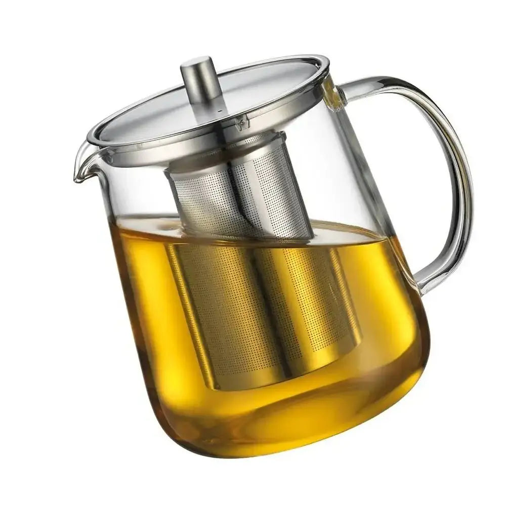 Clear glass teapot with metal infuser and handle on a white background