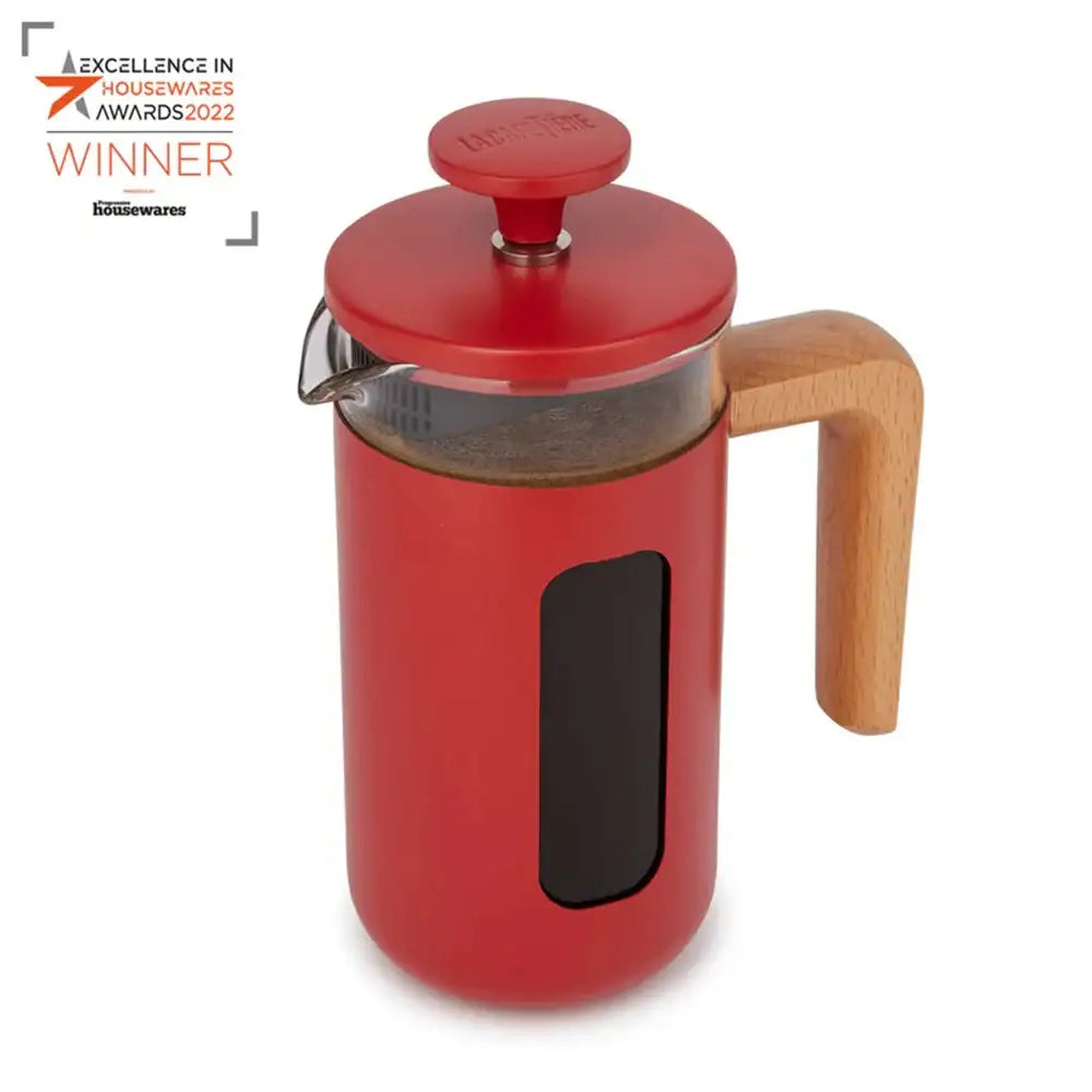 Red French press coffee maker with wooden handle on a white background, featuring an award badge.