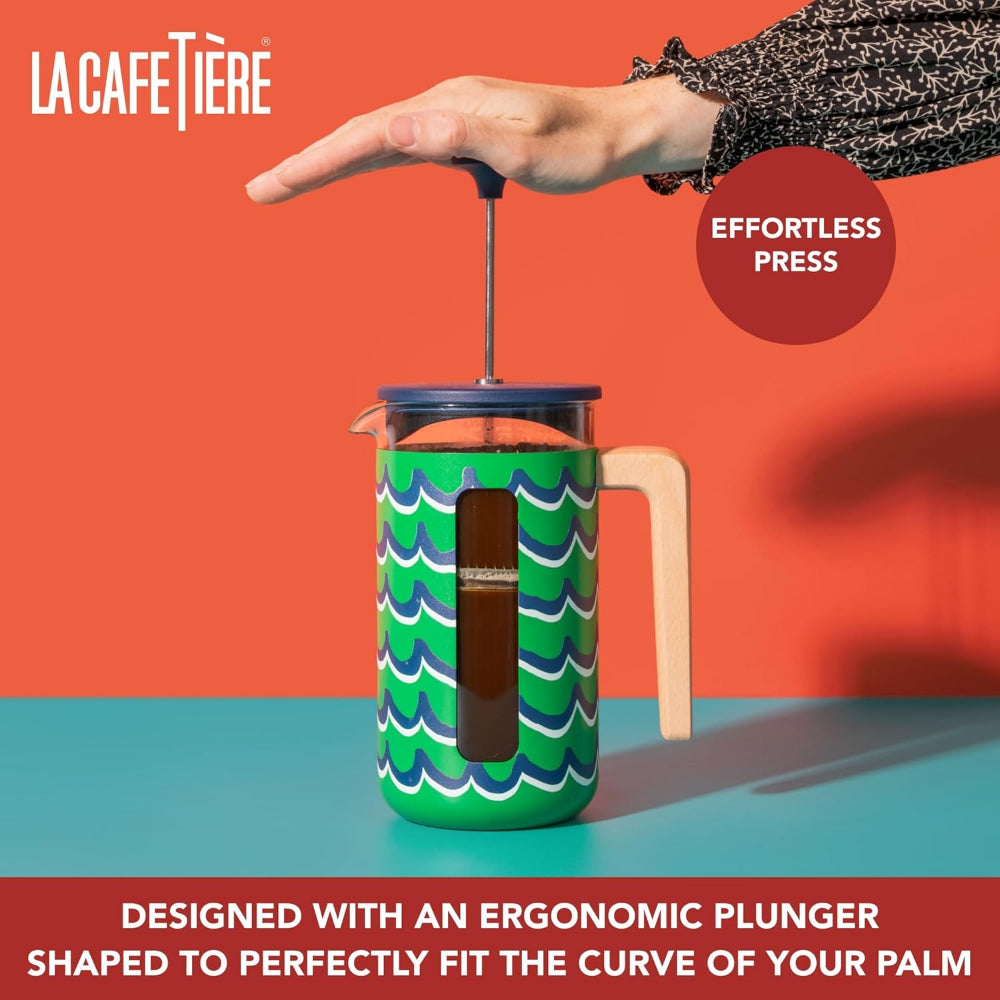 La Cafétière French press with ergonomic plunger against an orange background