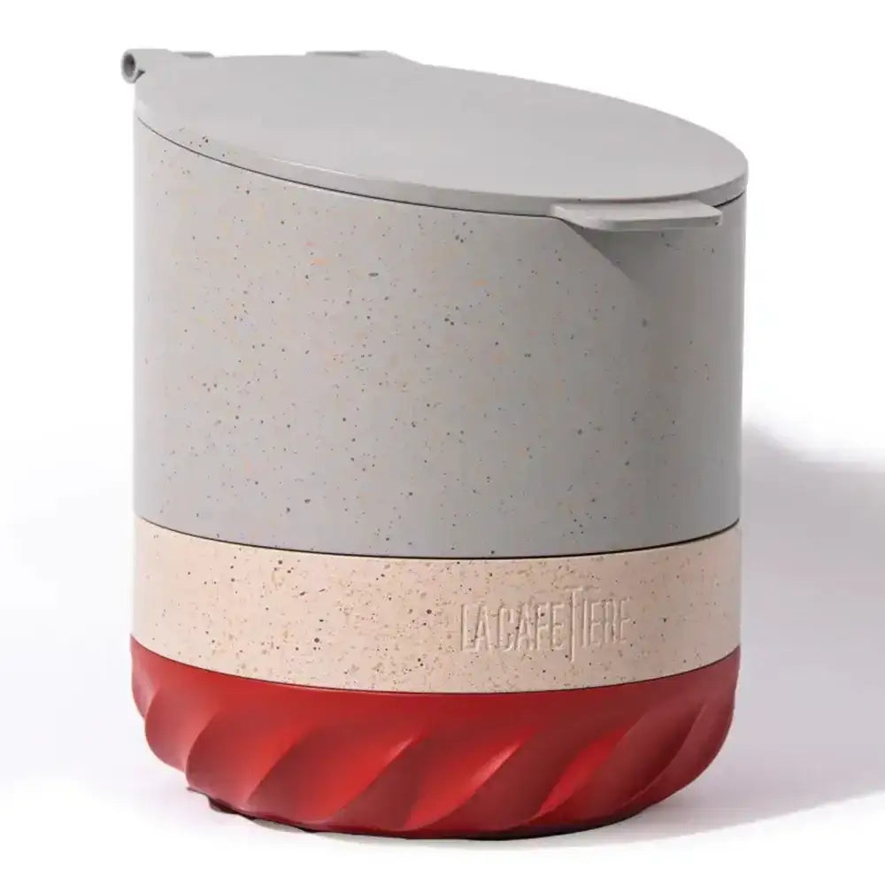 Multicolored container with speckled pattern and red base on a white background