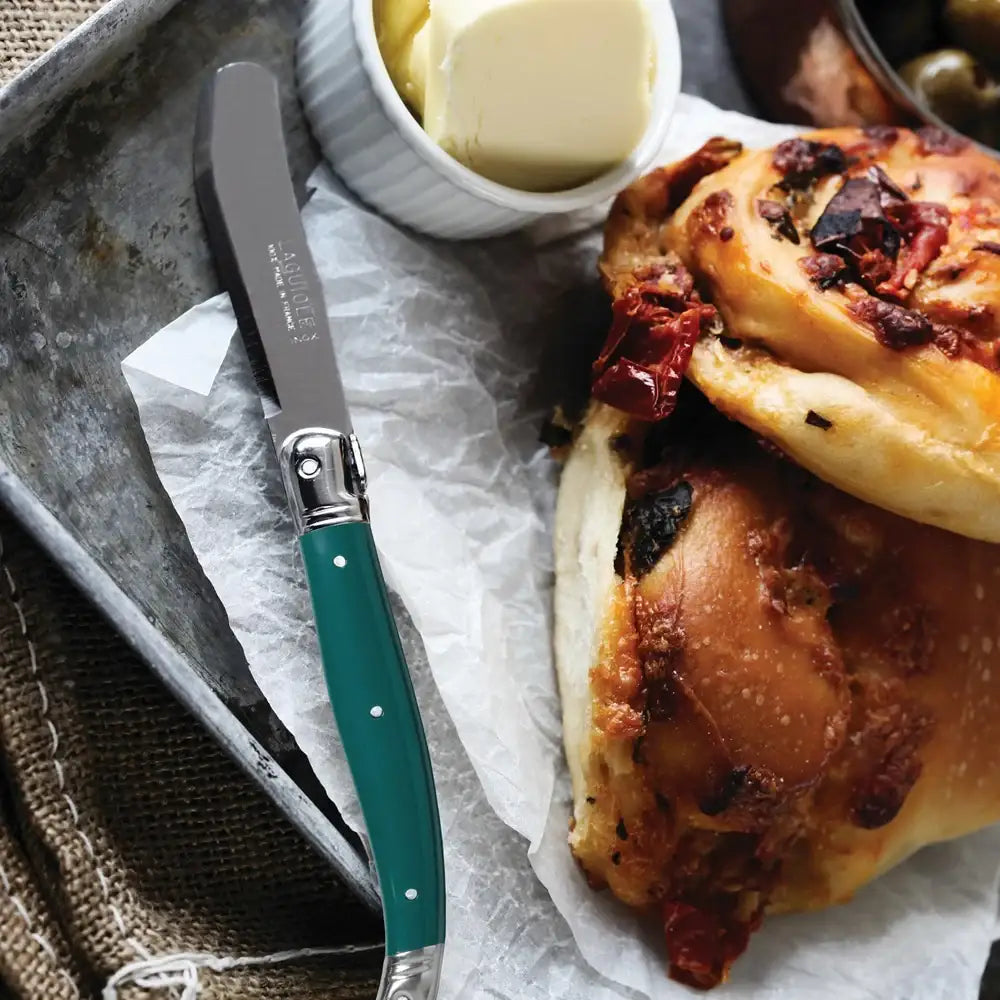 Baked dish with a knife and butter on a tray
