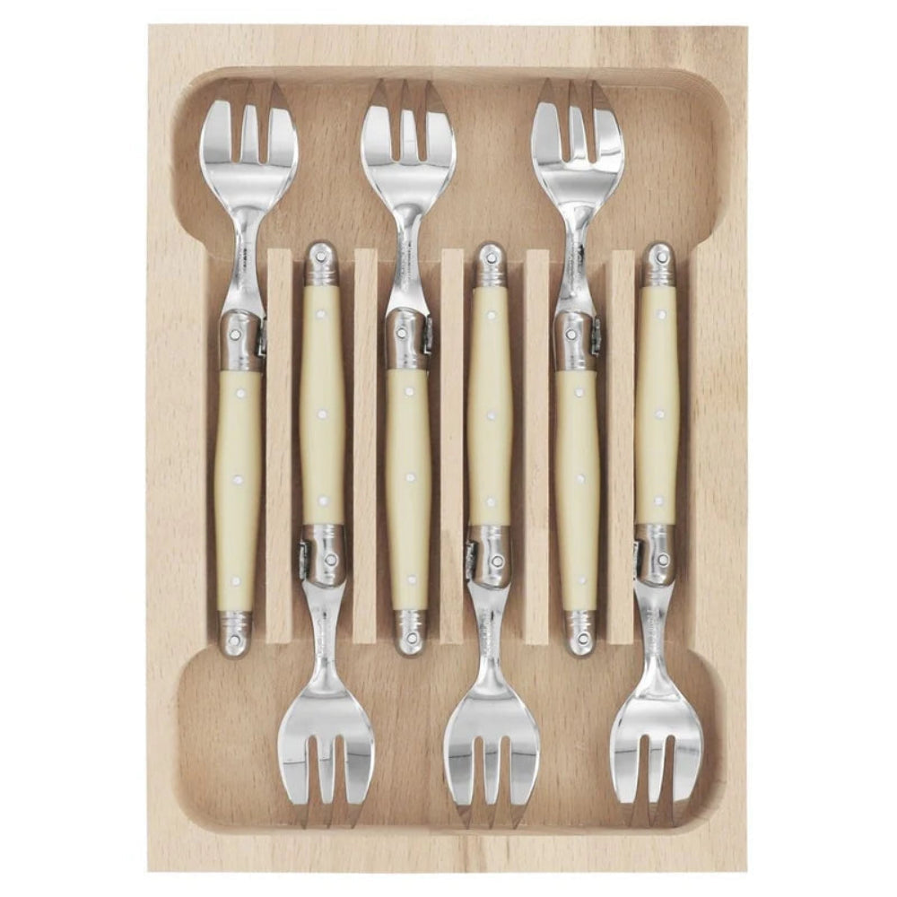 A set of six folding forks with cream-colored handles and silver metal heads, neatly arranged in a light wood storage tray on a white background.