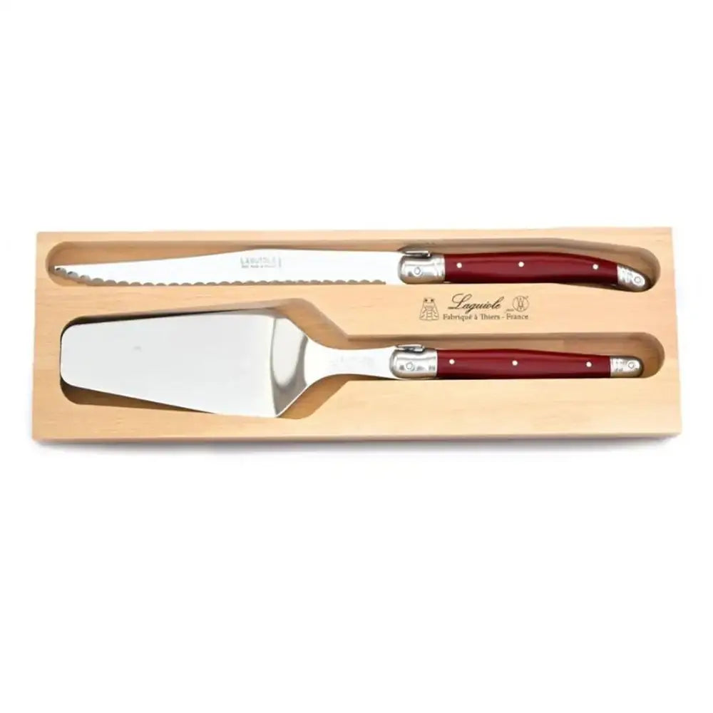 Two knives with red handles in a wooden box on a white background