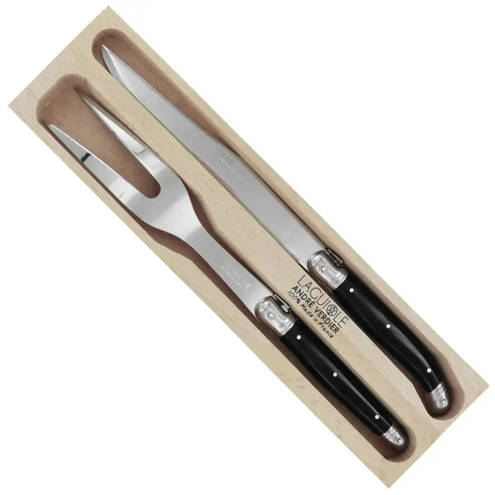 Set of two metal carving utensils with black handles in a wooden box on a white background