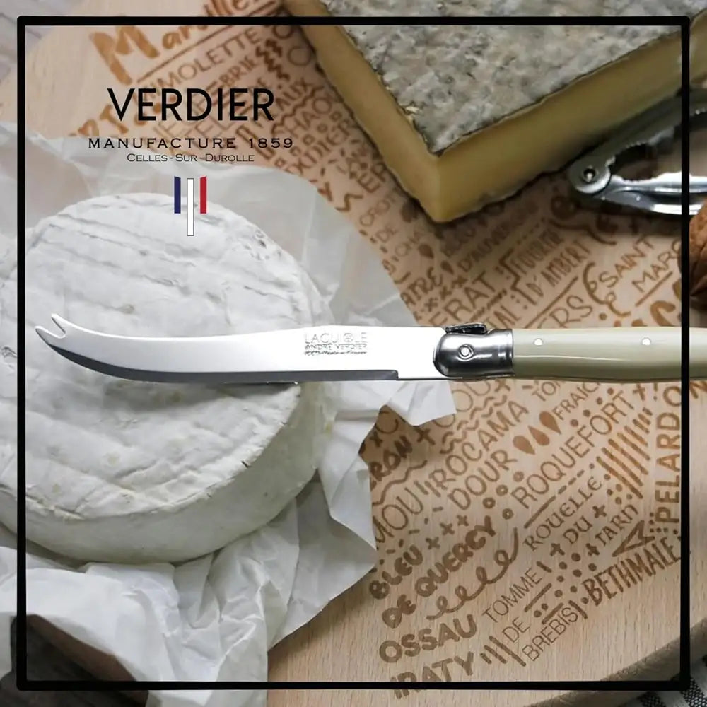 Butterknife on a cheese wheel with 'Verdier' branding on a patterned surface