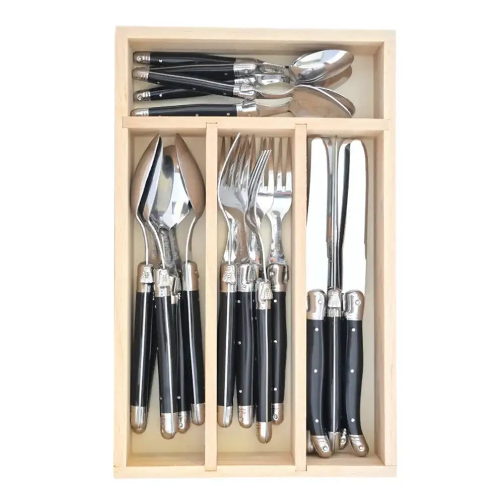 Set of cutlery with black handles in a wooden organizer on a white background