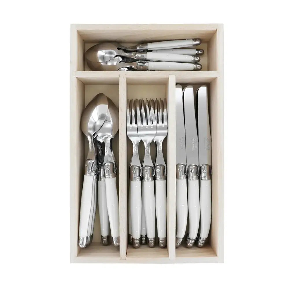 Set of silverware with white handles in a wooden drawer organizer on a white background