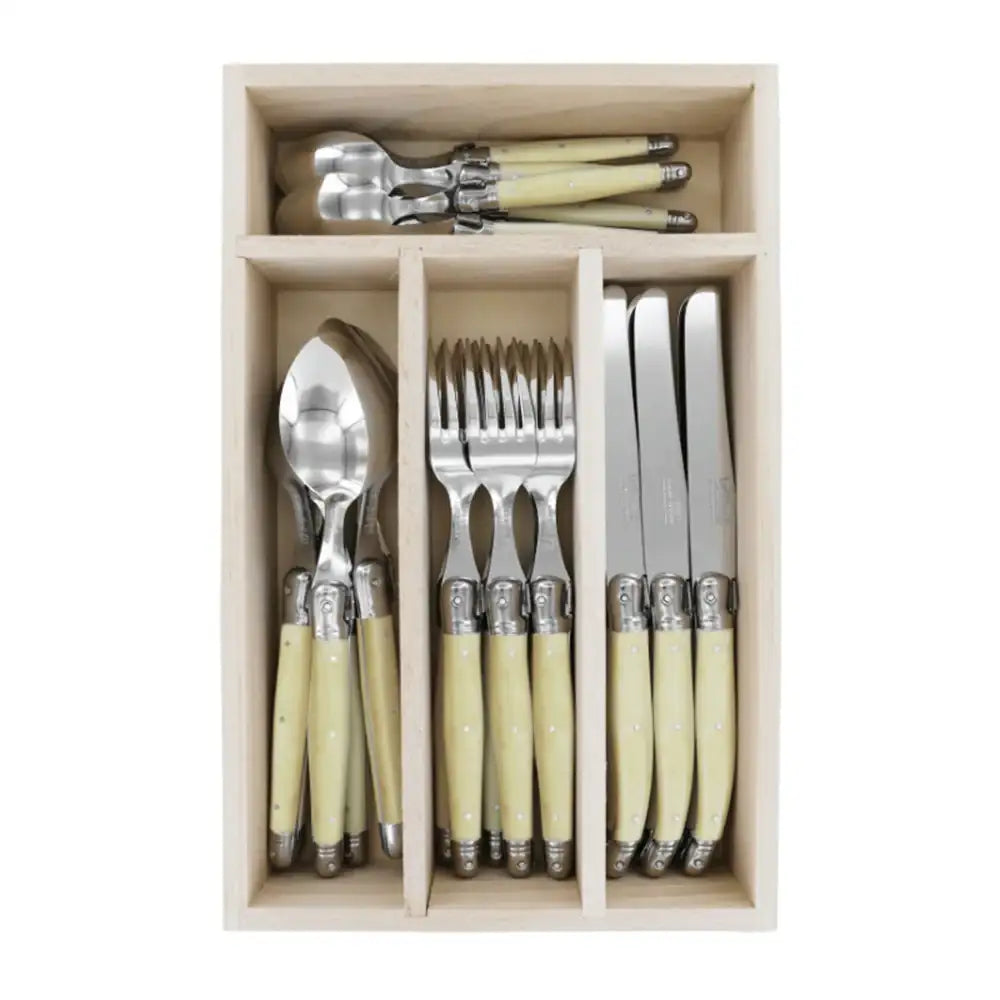 Set of cutlery with ivory handles in a wooden box on a white background