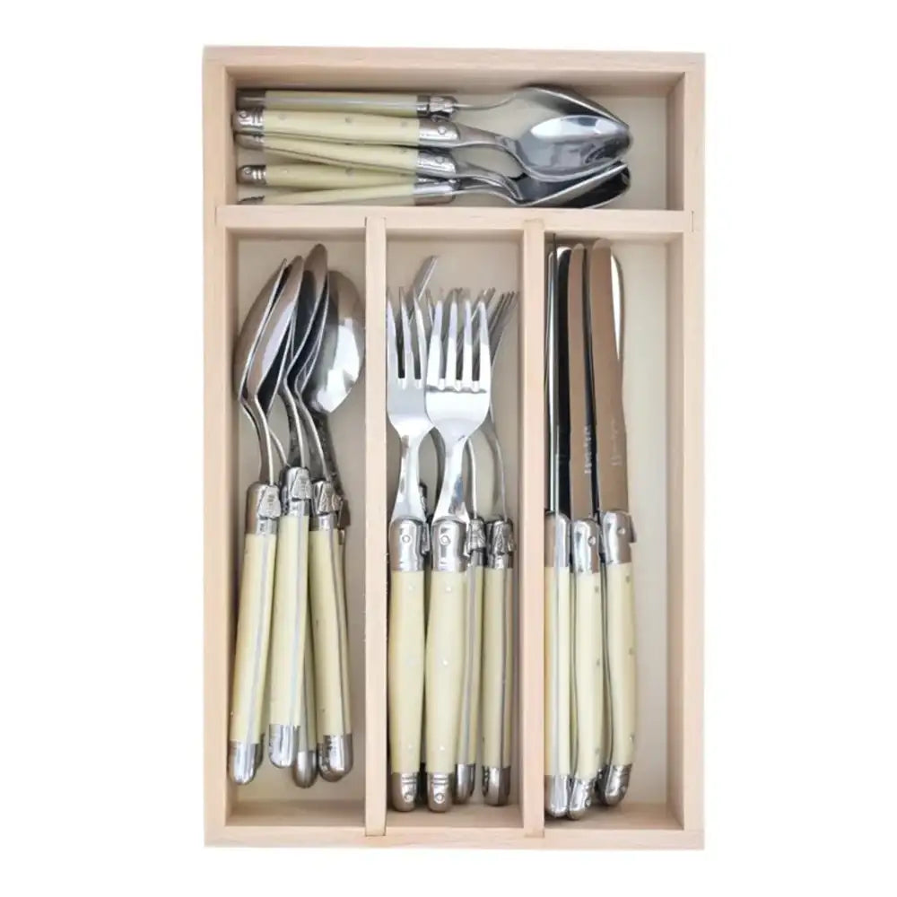 Set of cutlery with cream handles in a wooden drawer organizer on a white background