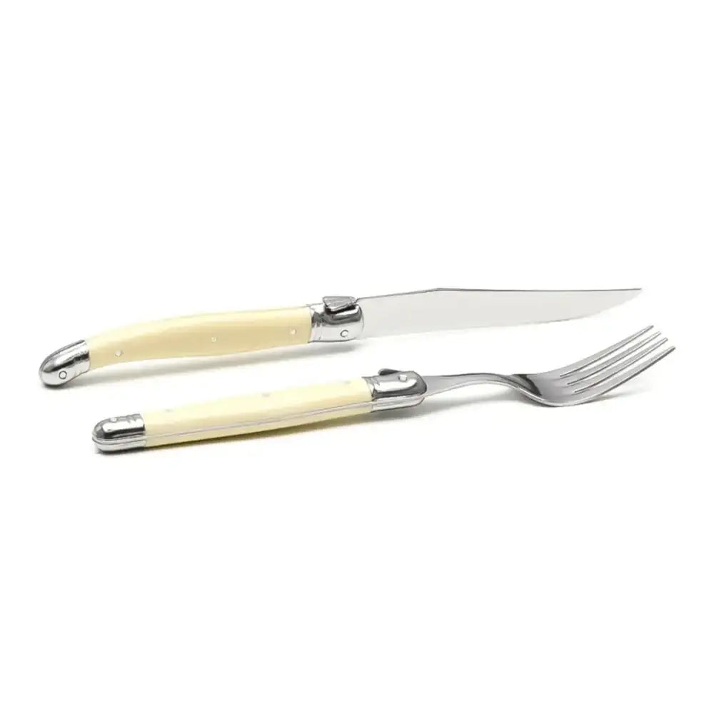 Set of knife and fork with cream-colored handles on a white background