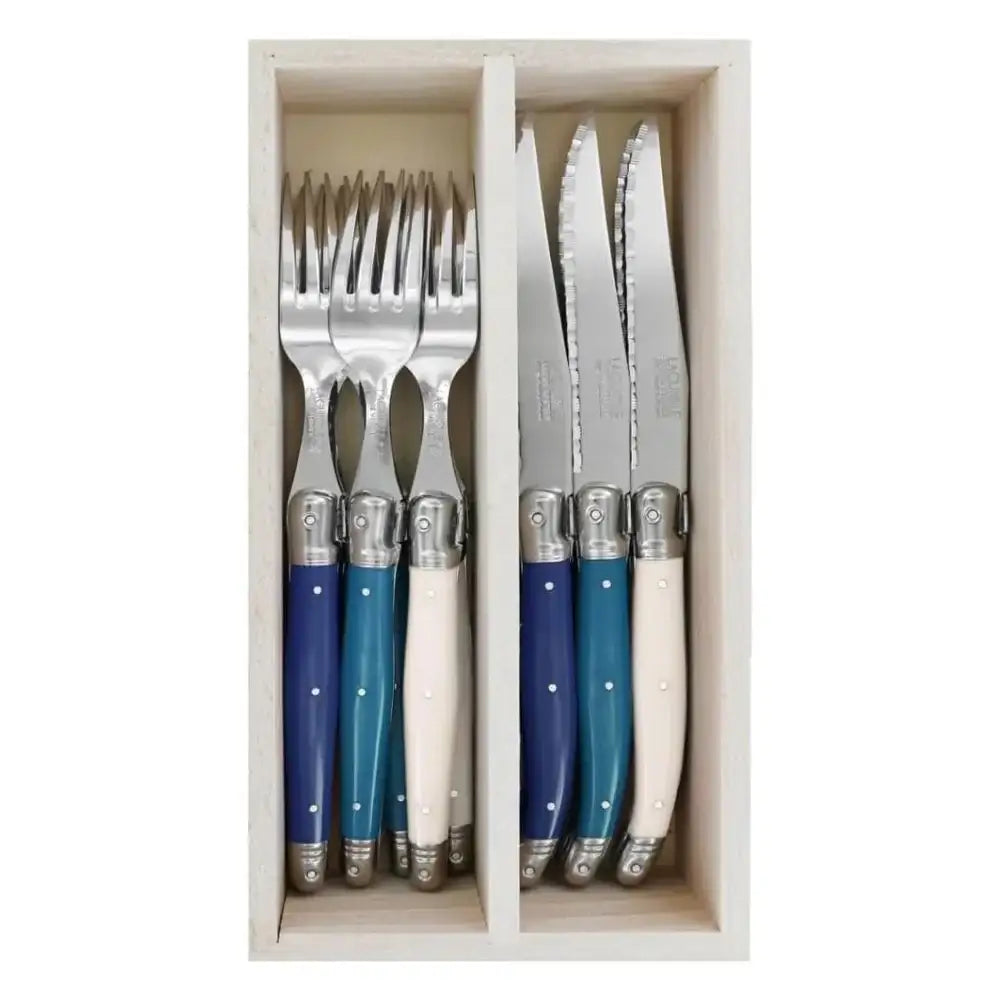 Set of cutlery with blue and white handles in a wooden box
