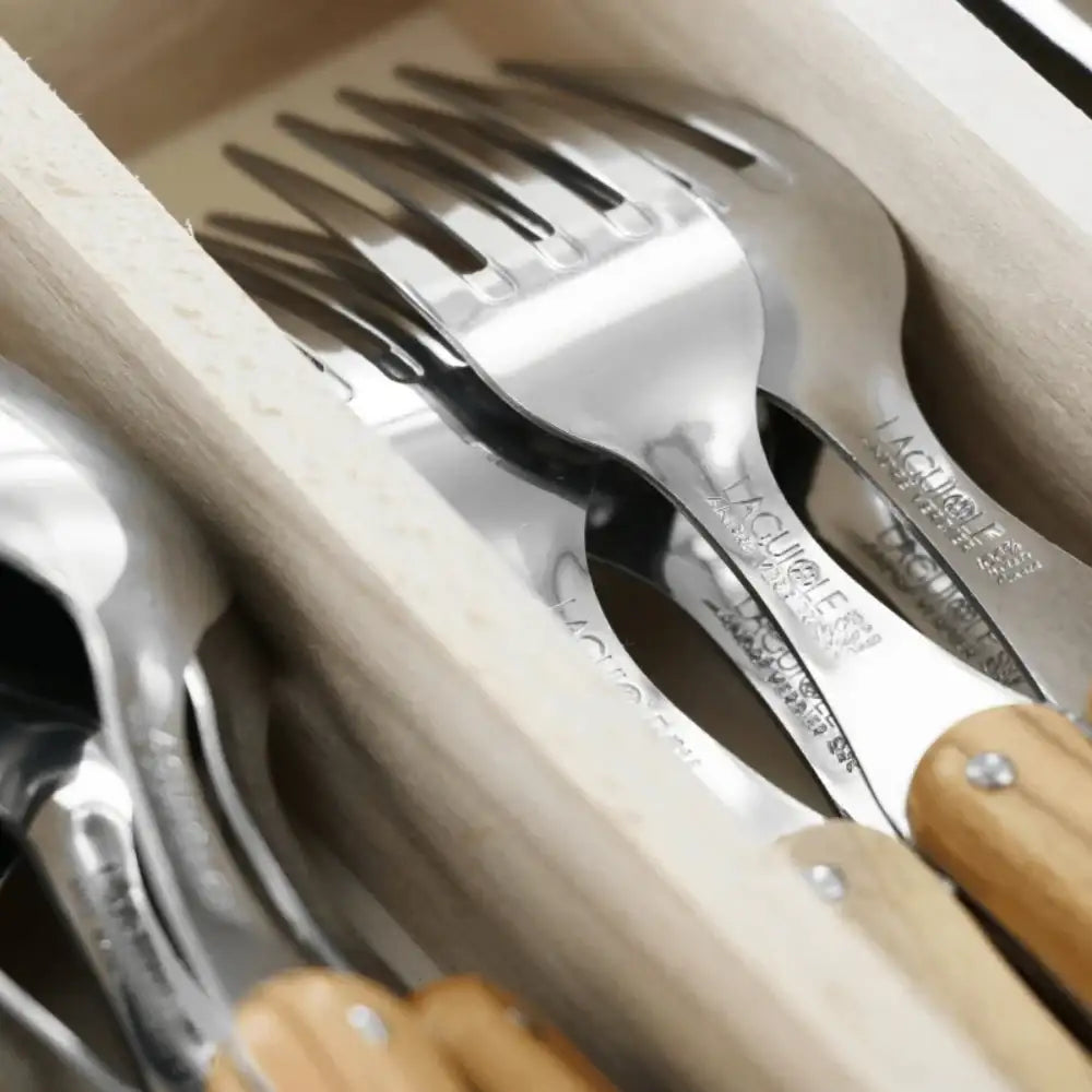 Set of silver forks with wooden handles in a wooden box
