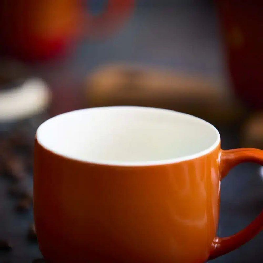 Orange mug with a blurred background