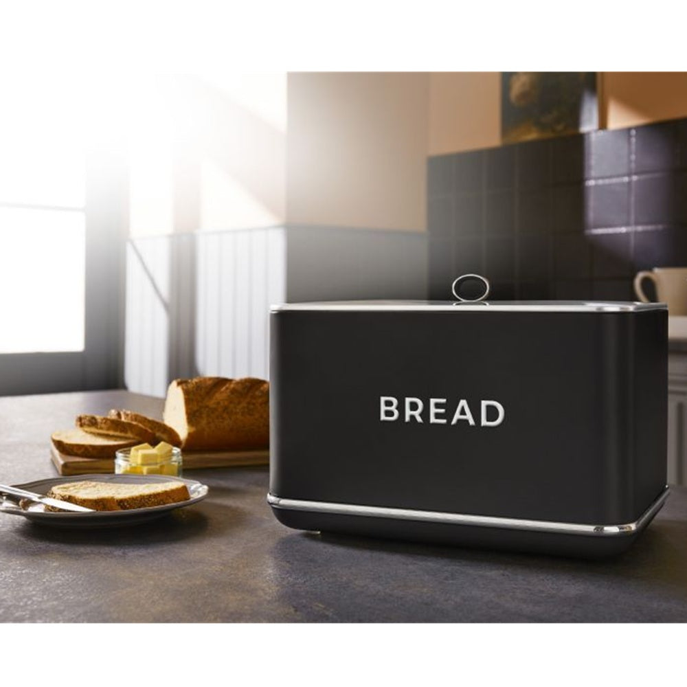 Le Morgan Black bread bin with 'BREAD' text on a kitchen counter with toast and butter.