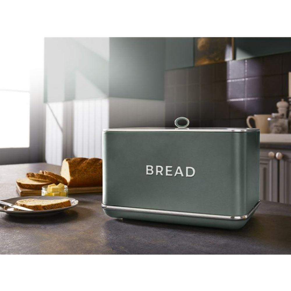 Green bread bin with 'BREAD' text on a kitchen counter