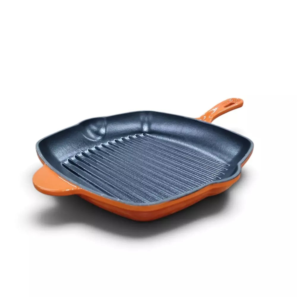 A Le Morgan Cast Iron Grill Pan 28cm Flame Orange with a dark gray non-stick interior and bright orange exterior, featuring a handle and side rests, shown on a white background.