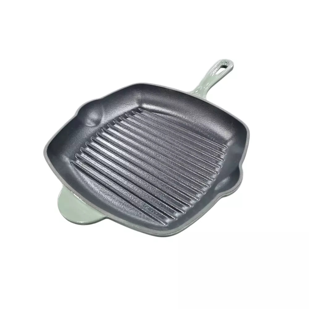 Green cast iron grill pan on a white background