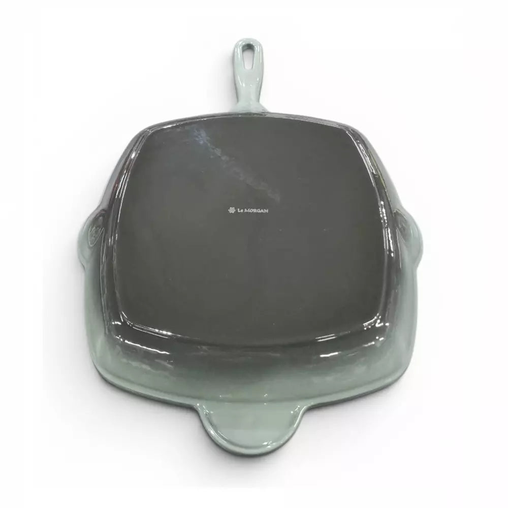 Green cast iron grill pan on white background