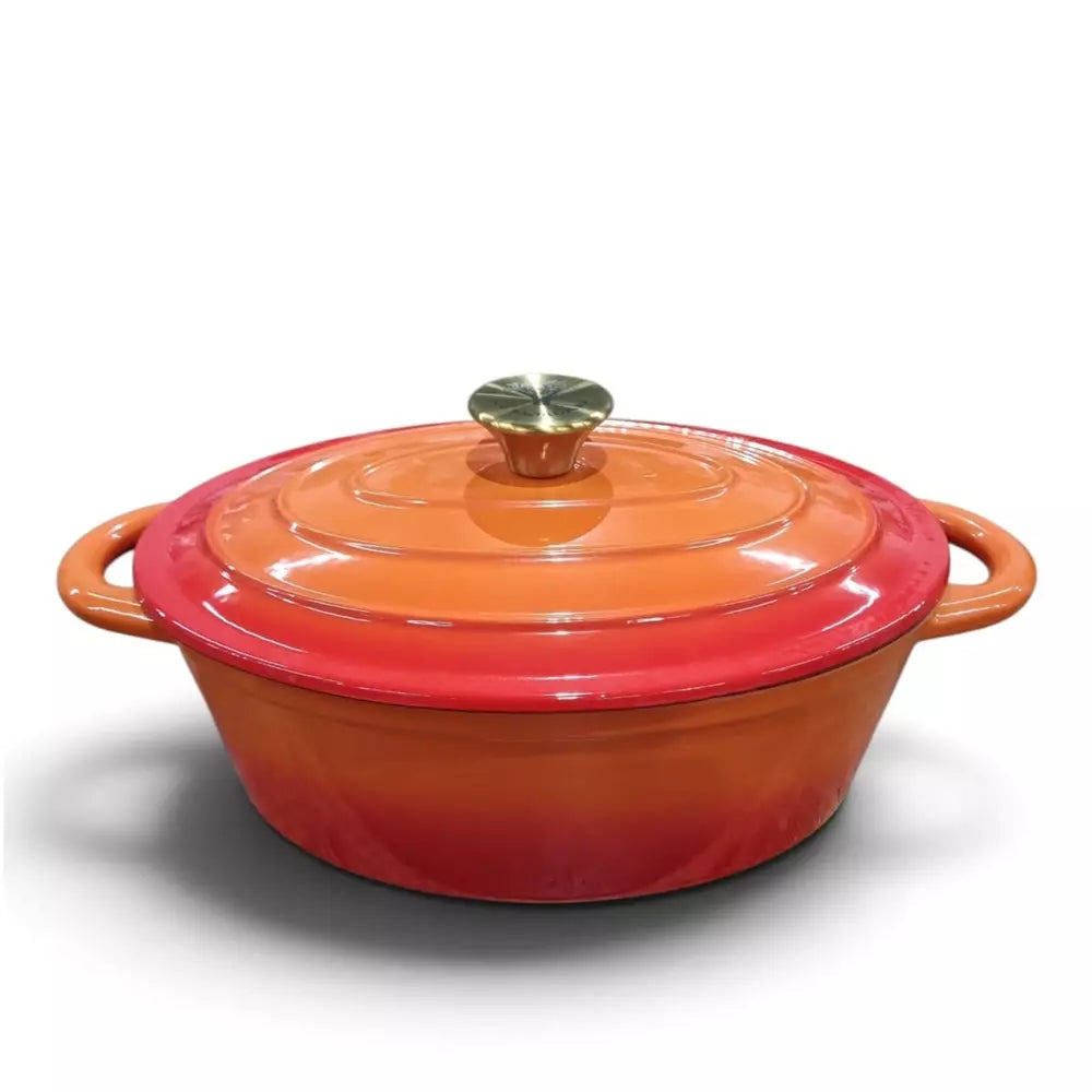 A Le Morgan Cast Iron Oval Casserole Pot 29cm Flame Orange enameled cast iron Dutch oven with a lid, featuring a vibrant orange and red gradient finish with a small metallic knob on top, set against a plain white background.