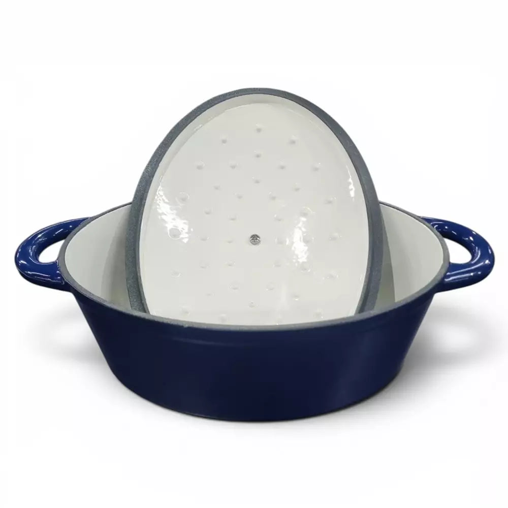 Blue enameled cast iron casserole dish with a white interior on a white background