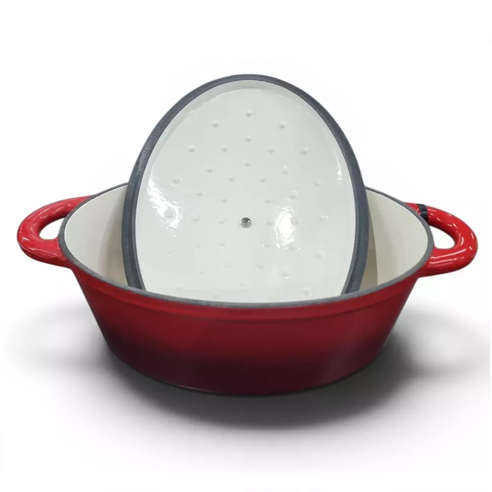 Red enameled cast iron casserole pot with a white interior on a white background