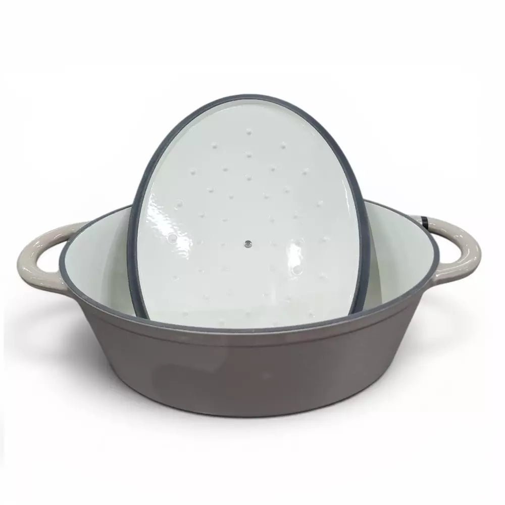 Beige enameled cast iron casserole pot with lid on a white background