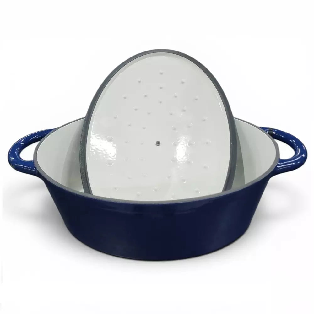 Blue enameled cast iron casserole pot with a glass lid on a white background