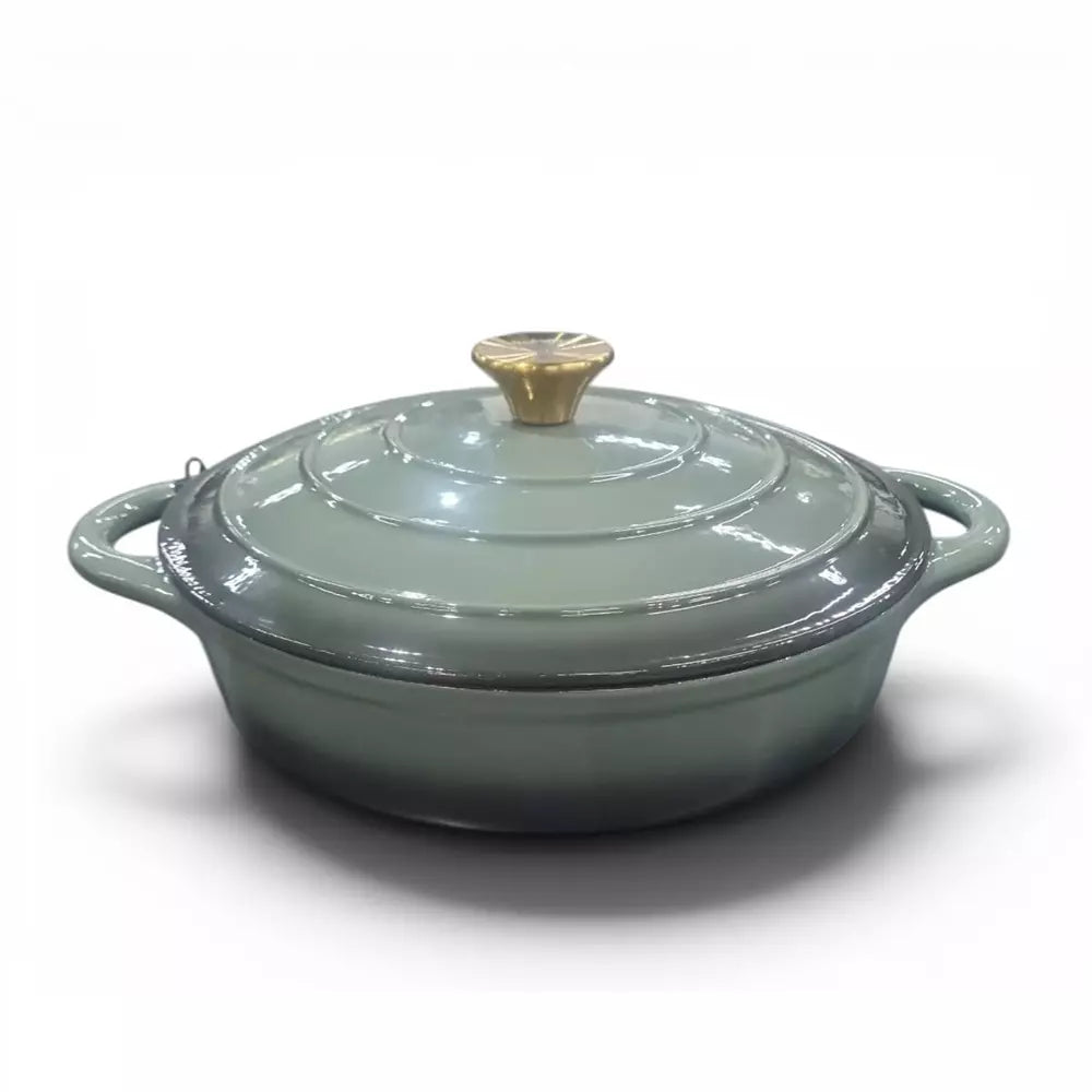 Green enameled cast iron casserole dish with lid on a white background