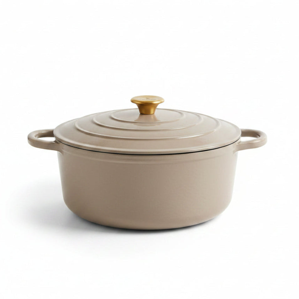 Beige enameled cast iron Dutch oven with a lid on a white background