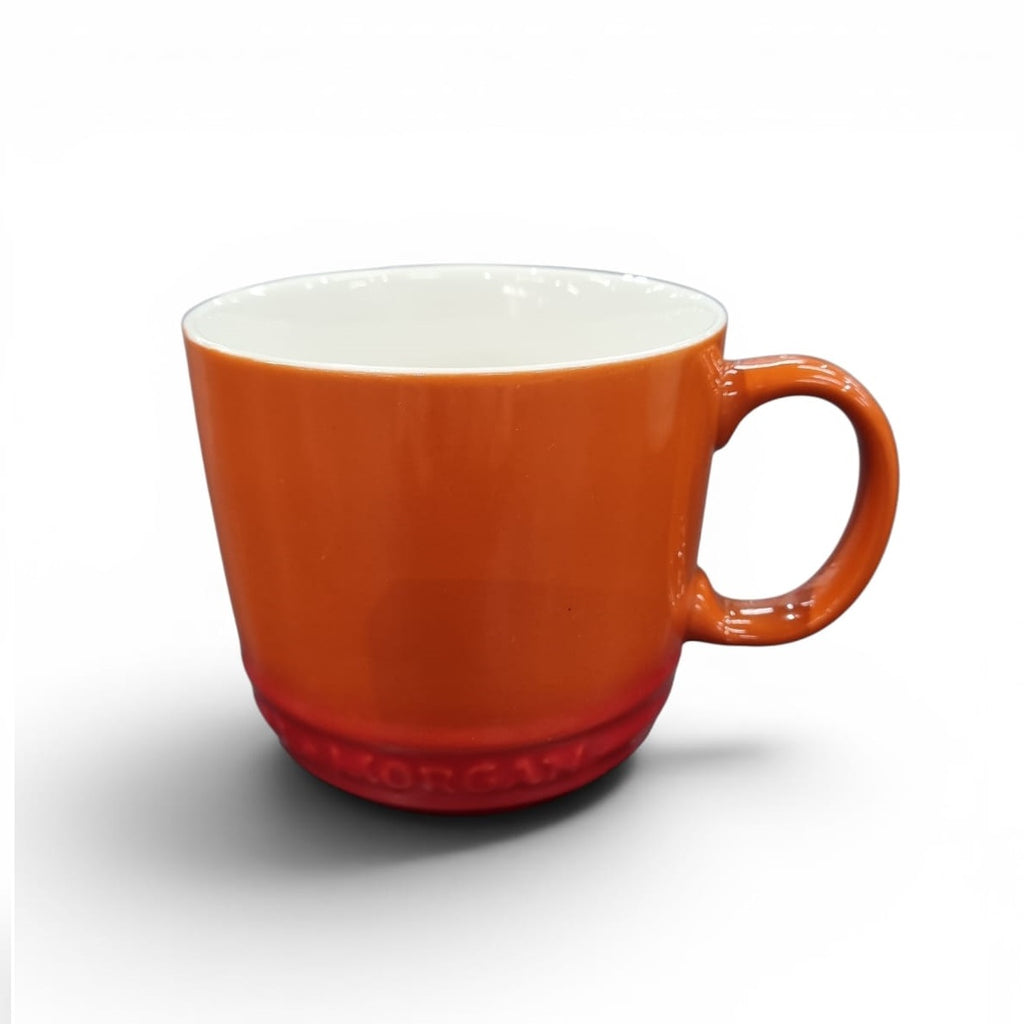 Orange mug with a white interior on a white background