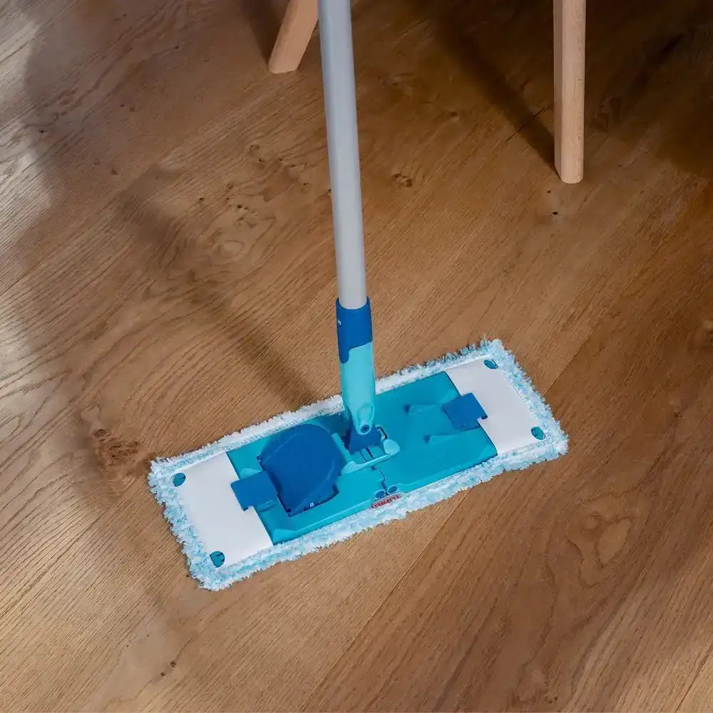 Blue and white cleaning mop on a wooden floor