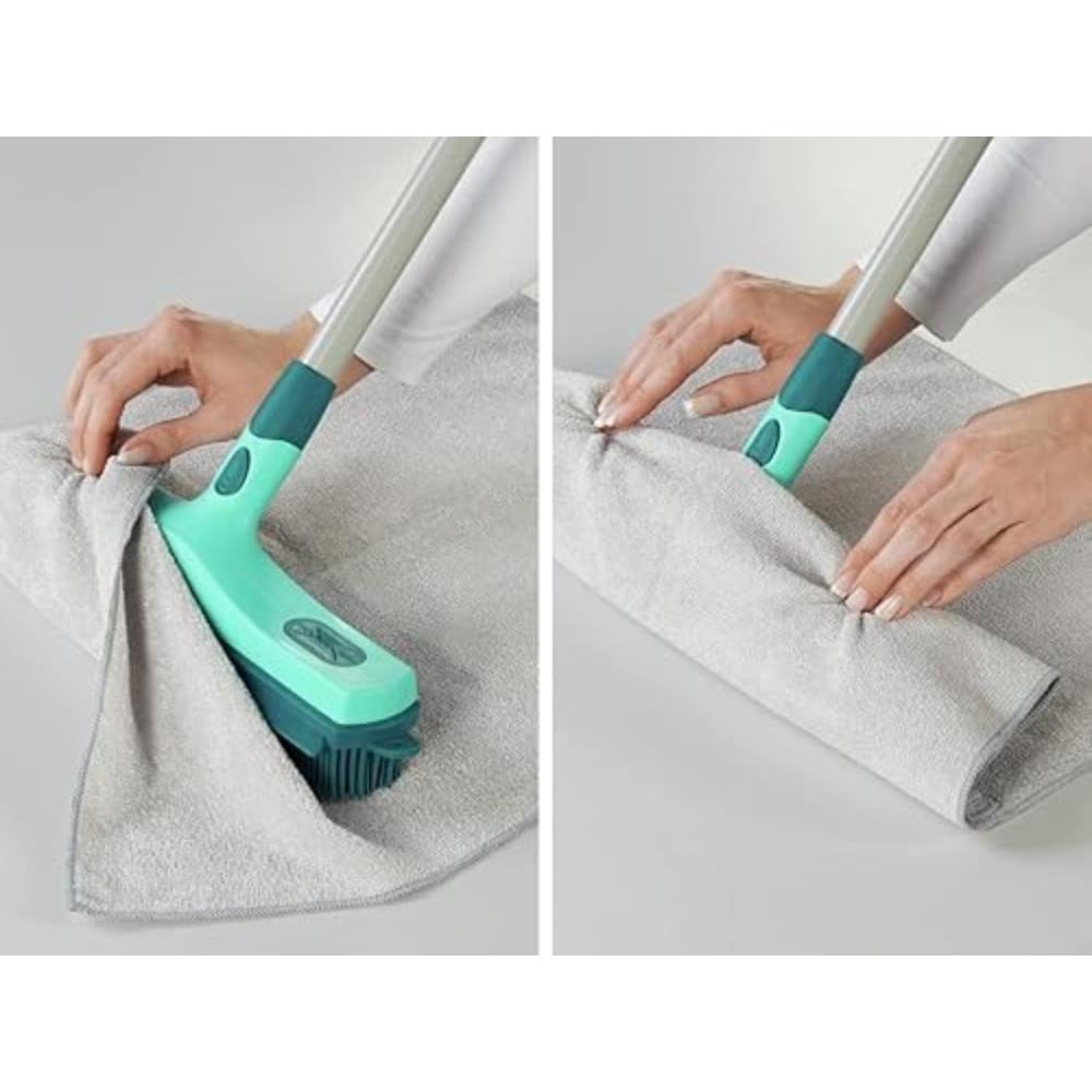 Green cleaning brush with a gray towel on a light gray background