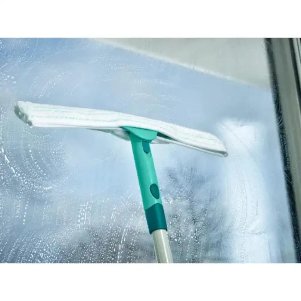 Window cleaning tool with a squeegee on a glass surface