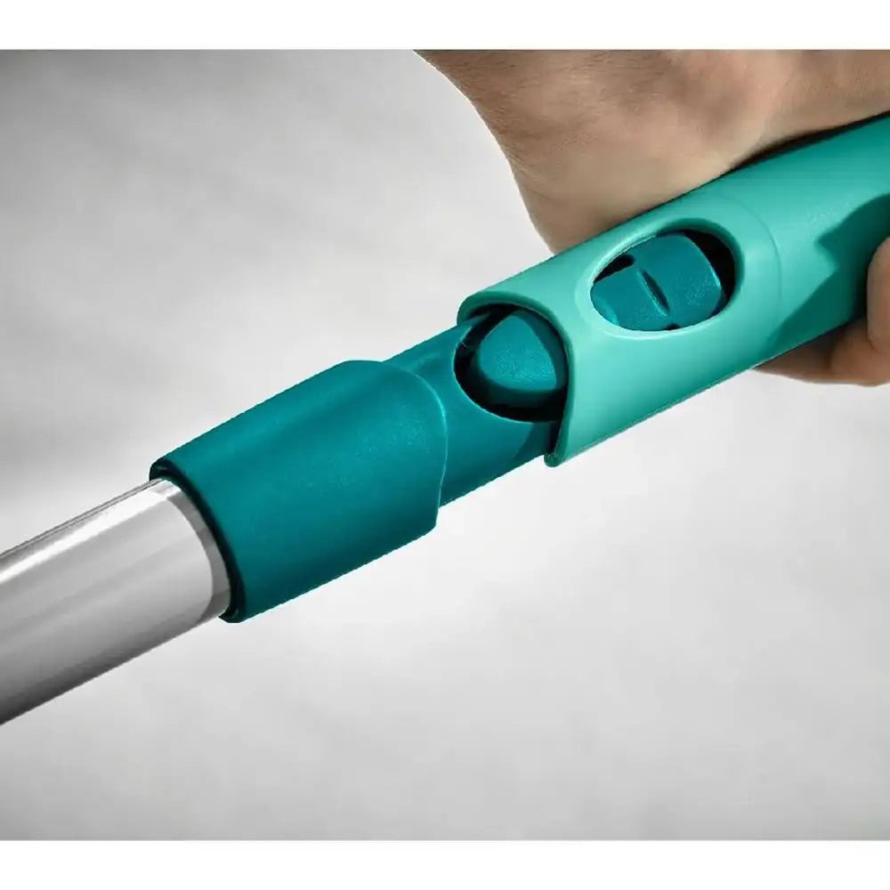 Teal cleaning tool handle held by a person on a gray background