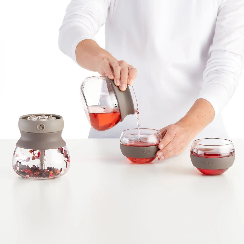 Person pouring tea into a glass