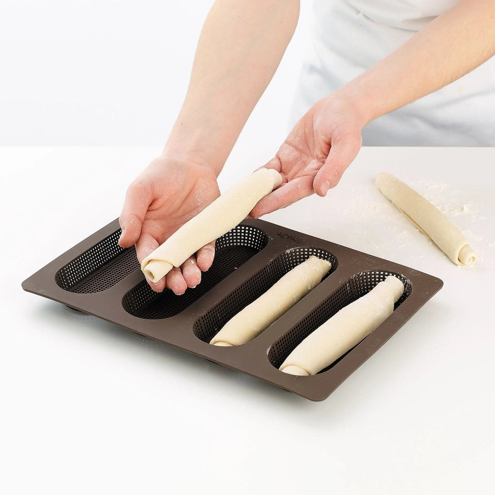 Person placing dough into a loaf pan 