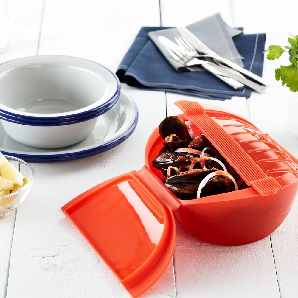 Steamed mussels in an orange container with napkins and bowls in the background