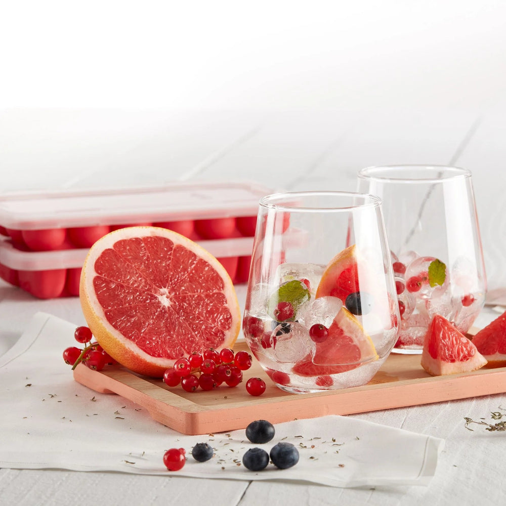 Drinks with ice and fruit on a wooden surface 