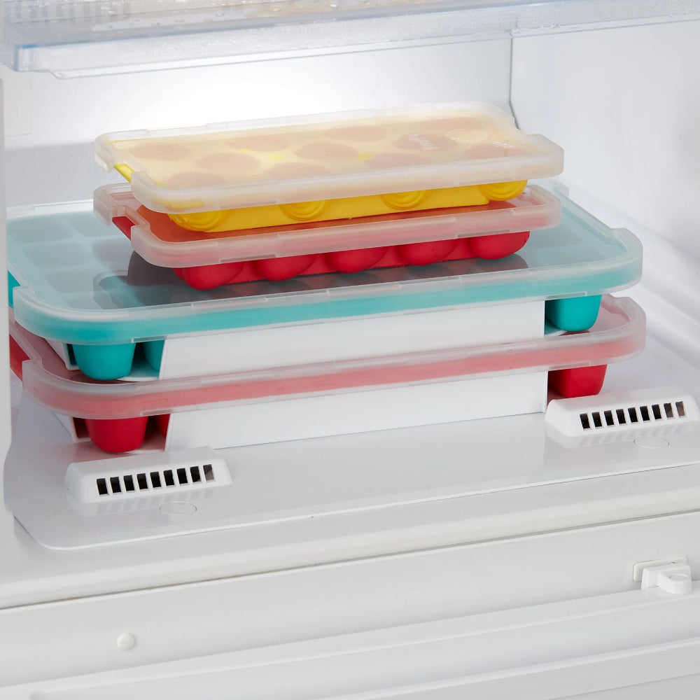Ice cube trays stacked in a freezer