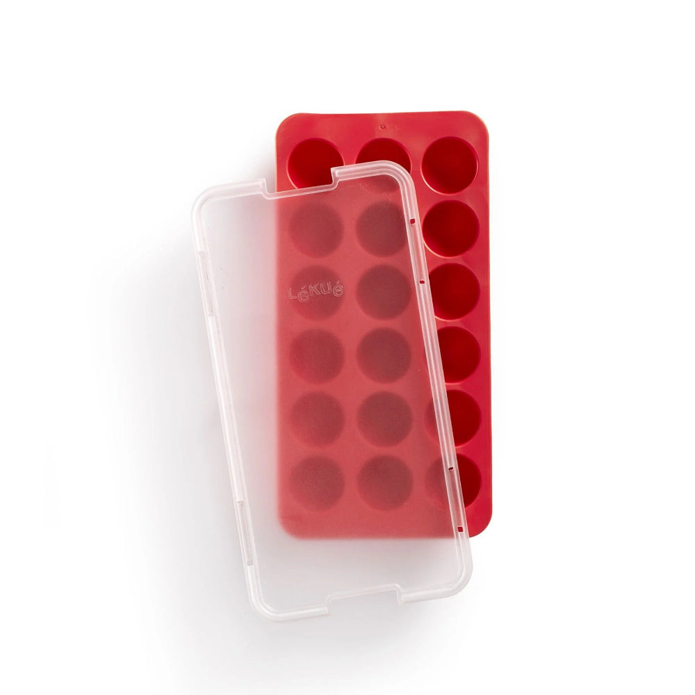 Red round ice cube tray with lid on a white background 