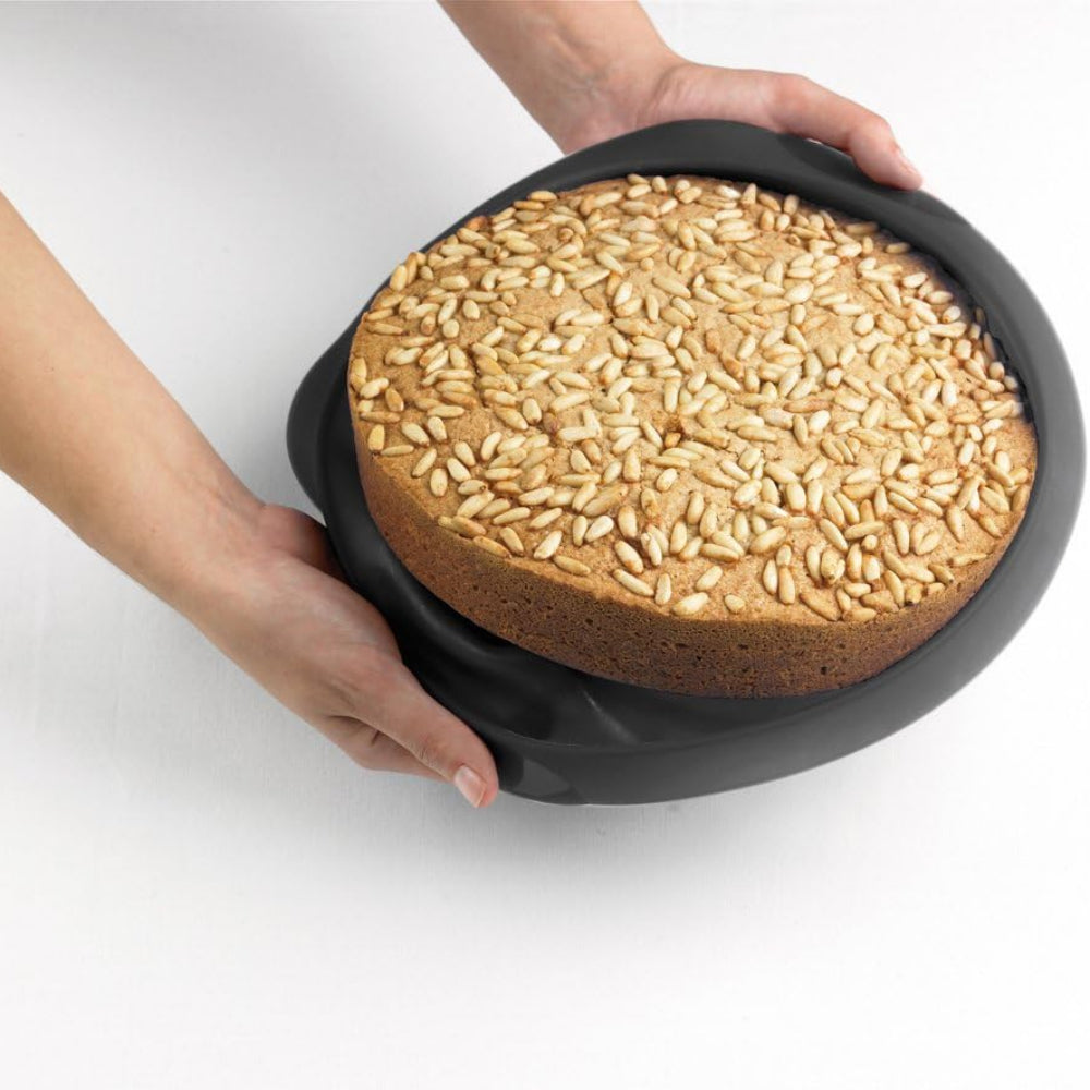 Person removing cake from a round cake pan 