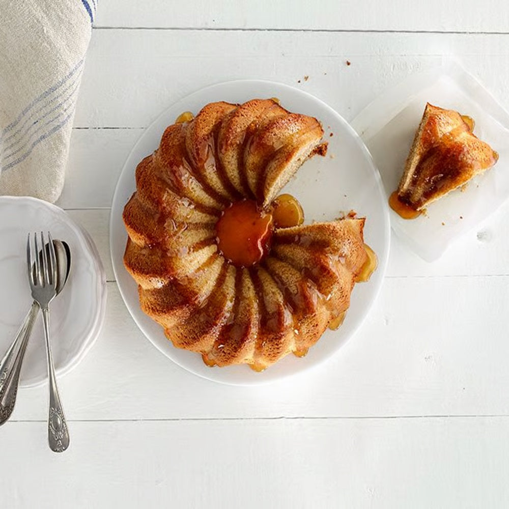 Bundt style cake on a white surface 