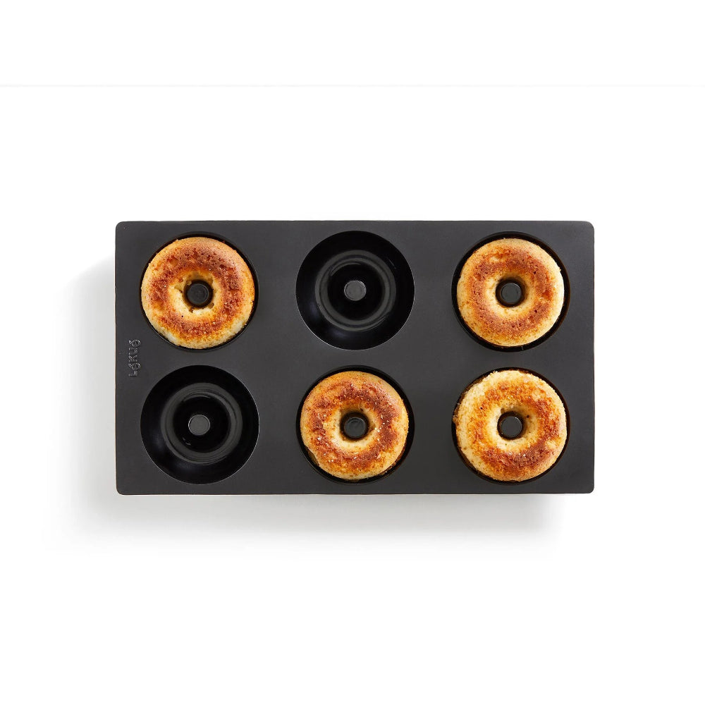 Black doughnut mould on a white background