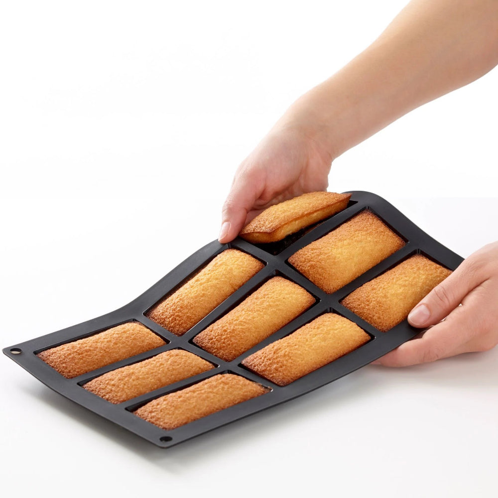 Person removing mini cakes from a silicone mould 