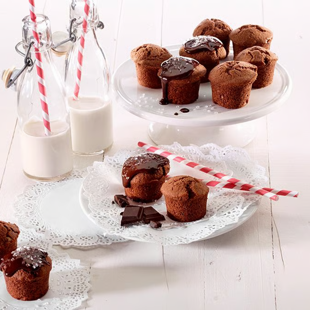 Chocolate muffins on a wooden white surface 